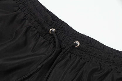 Shorts de playa con letras rosas bordadas